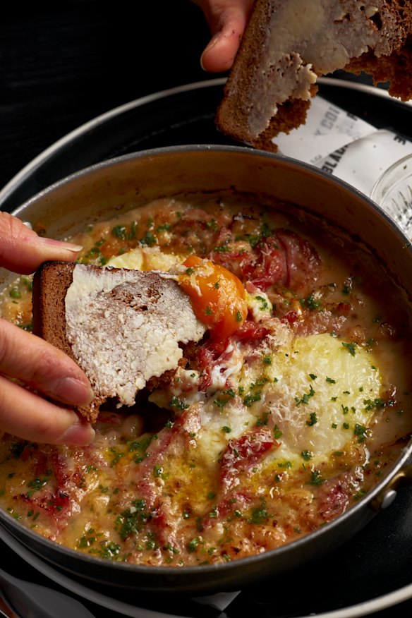 Baked eggs with truffled white beans and smoked ham hock.