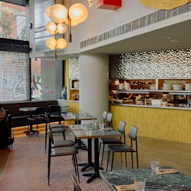 Green-marble tables and mustard-yellow tiles ooze low-key luxury.