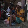 A woman holds her child at a shelter for families displaced by gang violence in Port-au-Prince, Haiti, Tuesday, Jan. 27, 2026.