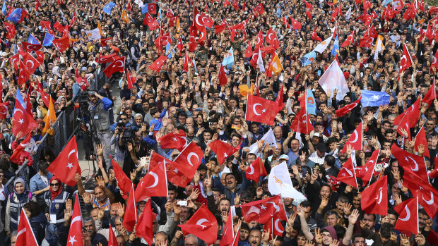 Supporters of Turkey's President Recep Tayyip Erdogan's ruling Justice and Development (AKP) Party, listen to his speech during a rally in Mersin, southern Turkey, on Saturday.