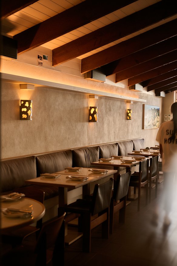 Banquette seating beneath timber beams.