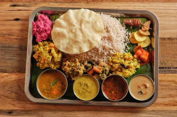 Sadhya, a traditional dish of 12 different elements served on a banana leaf.