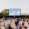 People sitting in front of the screen at the Manly Open Air Cinema