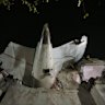 The tail of the Air India plane is seen stuck in a building at the site of the crash in India’s northwestern city of Ahmedabad in Gujarat state.