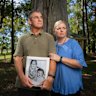 Paul and Linda Grimmer pose for photos with a framed photograph of Paul and his younger sister Cheryl in the 1970s.