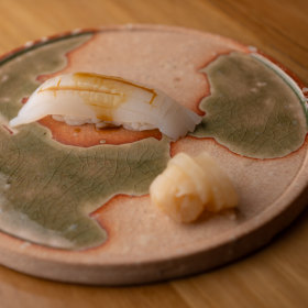 Cuttlefish nigiri with sea urchin soy sauce.