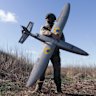 A Ukrainian soldier holds a new model of attack drone, reflecting the changing nature of modern warfare.