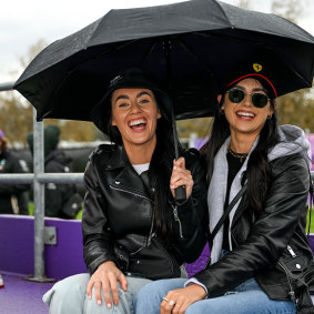 Sydneysiders Ash Murray and Edel Ryan seek shelter under their brolly