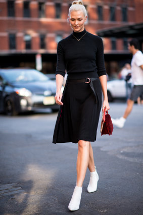 Karlie Kloss in white boots, one of the hottest trends of the season. Or is it?