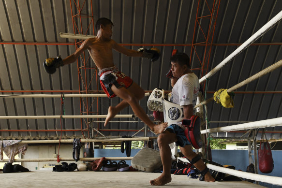 Phuton, 12, trains with his father a former Muay Thai champion.