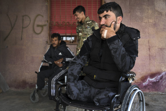 Syrian Democratic Forces soldier Swar Rojdam, 23, right, with fellow injured soldiers.