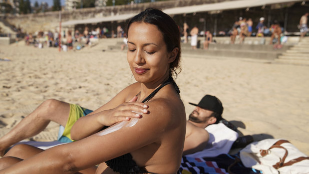 Serene Amaral from Waterloo applies some sunscreen at Coogee Beach on Sunday morning.