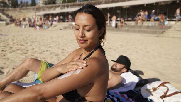 Serene Amaral from Waterloo applies some sunscreen at Coogee Beach on Sunday, when temperatures hit 38 degrees.