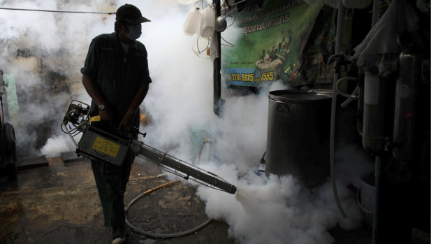 A Bangkok worker fogs a home with mosquito repellent after a Zika outbreak in 2013. 