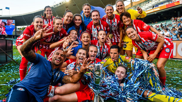 Dream team: Melbourne City coach Patrick Kisnorbo (left) with his players after City's 2018 W-League grand final win.