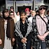 Aahana Nag, 18, is flanked by supporters as she appears at Brisbane Magistrates Court for vandalising Peter Dutton’s Arana Hills office.