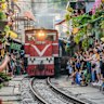 Several times daily a full-size train  make its way through Hanoi’s famous (or infamous) tourist train street. 