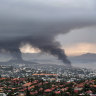 Smoke rises during protests in Noumea, New Caledonia.