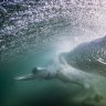 A swimmer enjoys unseasonably warm weather at Bondi.
