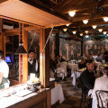 The main 50-seat dining room is lined with an Etruscan mural, giving it the air of a basement crypt.