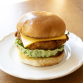 Fish burger made with hoki, cucumber pickles, mustard seed, lettuce and American cheddar.