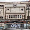The windows of the former Homebush theatre have been boarded up and its facade vandalised.