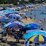 Cabanas and beachgoers at Safety Beach on the Mornington Peninsula.