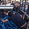 Palestinians children mourn over the body of their father, Mohammed Ghaben, who was killed while heading to an aid distribution hub, in Gaza City.