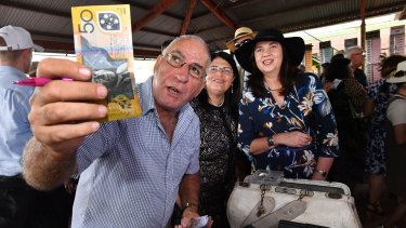Racing Minister Grace Grace and Premier Annastacia Palasczcuk place a bet with bookmaker Trevor Byrnes at the Kumbia Race Club.