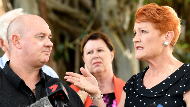 Pauline Hanson gestures to Thuringowa candidate Mark Thornton after being questioned about postings on his sex shop's Facebook page during a press conference in Townsville. 