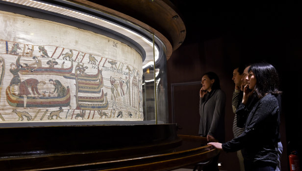 Visitors look at a section of the 70-metre Bayeux Tapestry, which is likely to be loaned to Britain for the first time.