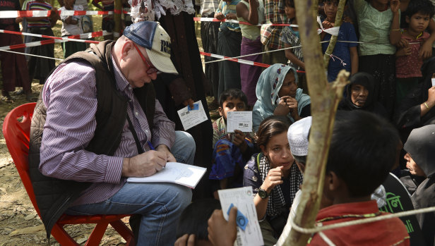 Lindsay Murdoch interviews Rohingya survivors at a food distribution in a Rohingya refugee camp in Cox’s Bazar, Bangladesh, last November.