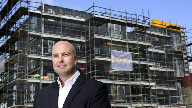 Three to four months of construction in two days: David Risbey from Evolve Housing outside the modular apartment block being built at Guildford.