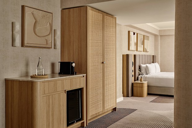 A neutral hotel room with lots of brown and beige