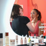 Australian player Lizette Cabera gets her makeup done by a MECCA make-up artist at the beauty bar for players. 
