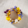 Fried pastry ring drizzled with green garlic oil and topped with edible flowers.