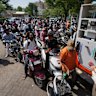 Motorists queue up to get fuel at a pump in Ahmedabad, India, this week.