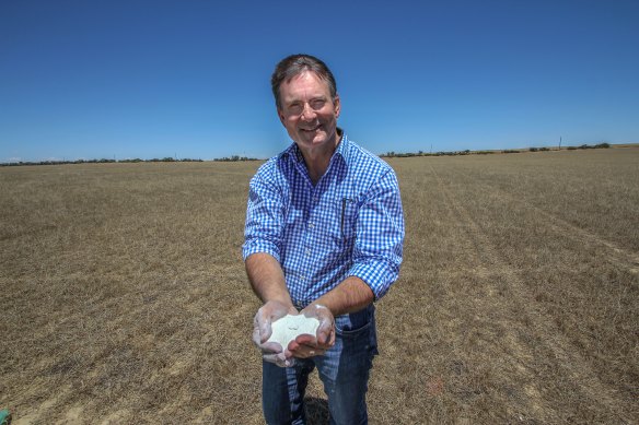 FYI Resources managing director Roland Hill holding a handful of kaolin at the site of their future Cadoux mine.