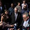 Brett Button, the driver of a charter bus that rolled and killed 10 weddings guests in the Hunter Valley, stands with head bowed as his lawyer reads an apology in Newcastle.
