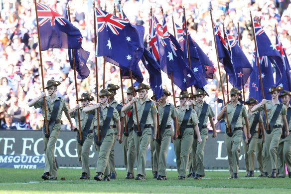 Special: Soldiers march onto the field before last year's Anzac Day match between the Roosters and the Dragons.