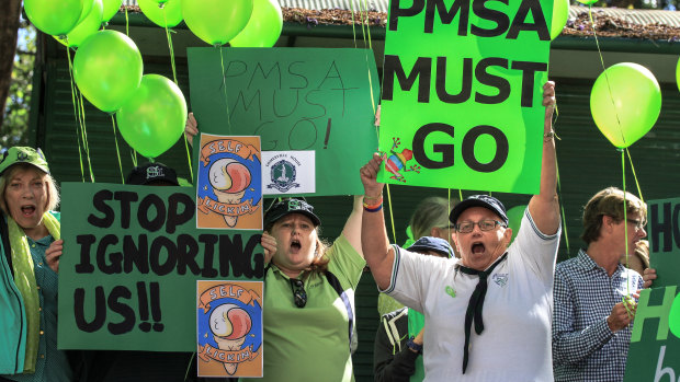 Parents don the green of elite Brisbane girls school Somerville House as they protest its governing body, the PMSA.