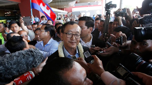 Former Cambodian opposition leader Sam Rainsy (centre) says Australia needs to do more to challenge the state of democracy in his homeland.