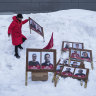 A woman arranges campaign posters in Nuuk, Greenland.