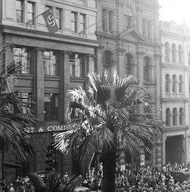 A demonstration taking place outside the German consulate in Bridge Street, Sydney where the Swastika flag was flying on Anzac Day 1939.