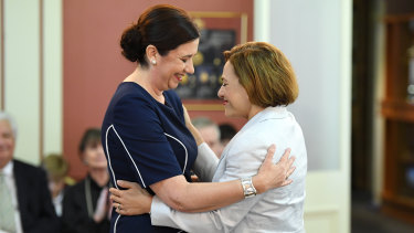 Queensland Premier Annastacia Palaszczuk (left) and Deputy Premier and Treasurer Jackie Trad embrace during the swearing-in ceremony at Government House.
