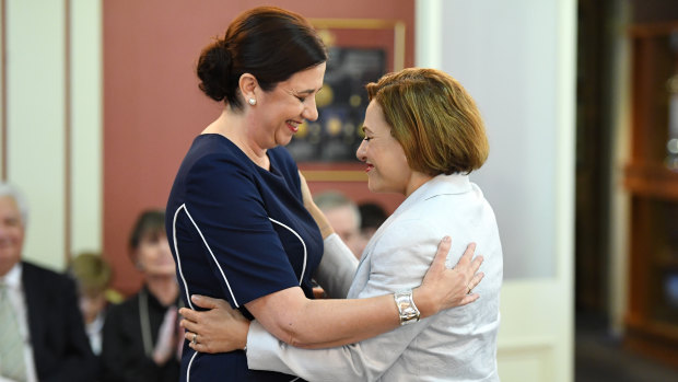Queensland Premier Annastacia Palaszczuk (left) and Deputy Premier and Treasurer Jackie Trad embrace during the swearing-in ceremony at Government House.