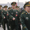 Military delegates march ahead of the opening session of the National People’s Congress at the Great Hall of the People in Beijing.