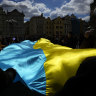 People wave with Ukrainian flag during a demonstration in support of Estonian military strategic plan for Ukraine at the Old Town Square in Prague, Czech Republic.