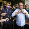 Malaysian opposition leader Anwar Ibrahim arrives at a hotel for talks on forming a governing coalition.