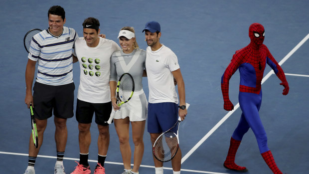 Canada's Milos Raonic, left, stands with Switzerland's Roger Federer, Denmark's Caroline Wozniacki and Novak Djokovic as they pose for a photo during the Kids Tennis Day.